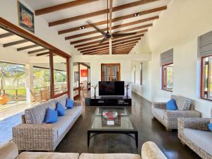 a living room with two couches and a tv at Villa Margot by Ceylon Spaces in Pamunugama