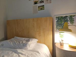 a bedroom with a bed and a lamp next to a table at Million House in Seoul