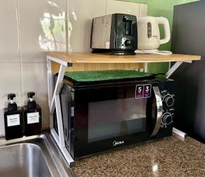 a microwave sitting on a counter next to a sink at 103-25 Kathu Waterfall in Phuket