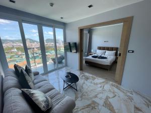 a living room with a couch and a bed at Emerald Terrace Resort 2 bedrooms Panoramic Ocean View Top Floor in Patong Beach +23 photos