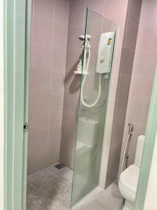 a bathroom with a glass shower with a toilet at Summer Suites by Western Holiday in Kuala Lumpur