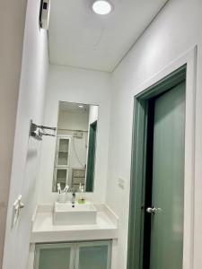 a bathroom with a sink and a mirror at Summer Suites by Western Holiday in Kuala Lumpur +40 photos