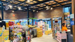 a store aisle with people in a grocery store at Summer Suites by Western Holiday in Kuala Lumpur