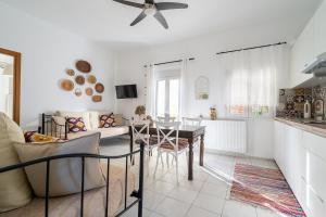 a living room with a ceiling fan and a table at Coastal Key 3 in Gázion