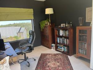 an office with a chair and a desk and a window at The Pijper House - Brackenridge Eco Estate Plettenberg Bay in Plettenberg Bay