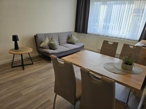 a living room with a couch and a table at Vario Gästehaus in Greifswald