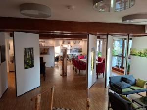 a living room and dining room with a table and chairs at Hotel Scharfes Eck in Mühlacker