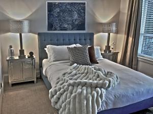 a bedroom with a blue bed with a blanket on it at Sand and Salt Bed & Breakfast in White Rock