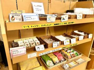 a store shelf filled with different types of cheese at Concept Hotel Wakyu in Toyama