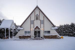 eine große weiße Kirche mit Schnee auf dem Boden in der Unterkunft ALL SEASON CAMP - Vacation STAY 21071v in Biei