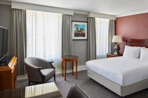 a hotel room with a bed and a desk and a chair at Delta Hotels by Marriott Durham Royal County in Durham +33 photos
