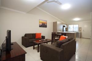 
a living room filled with furniture and a tv at Direct Hotels - Villas on Rivergum in Emerald
