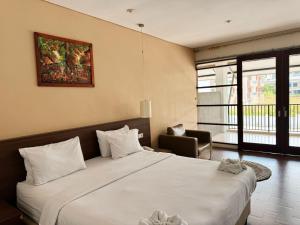 Ένα ή περισσότερα κρεβάτια σε δωμάτιο στο Hotel Ompu Herti