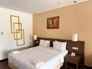 Ένα ή περισσότερα κρεβάτια σε δωμάτιο στο Hotel Ompu Herti