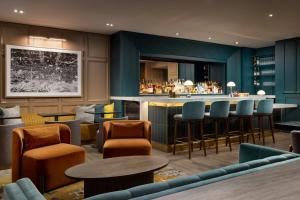 a bar in a restaurant with chairs and tables at Residence Inn by Marriott New York Downtown Manhattan/World Trade Center Area in New York