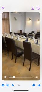 a dining room with a table with chairs and tablesktop at Pensiunea Cristina in Craiova