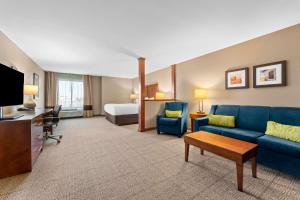 a hotel room with a couch and a bed at Comfort Inn & Suites Avera Southwest in Sioux Falls