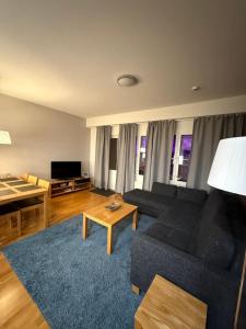 a living room with a couch and a table at Ruka Chalets Royal Apartments in Ruka