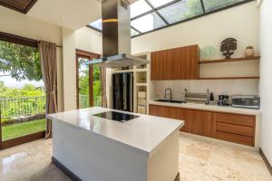 - une cuisine avec un comptoir et une cuisinière dans l'établissement Green GWK Villa, à Jimbaran