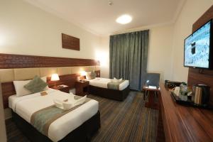 Voodi või voodid majutusasutuse Snood Al Rayan Hotel toas