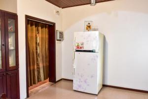 a white refrigerator freezer sitting in a room at Wicks Backpacker's Lodge - Peaceful Quality stay, Walk to the Historic Galle Dutch Fort and the beach in Galle