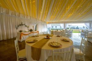 a dining room with a white table and chairs at The Anchorage in Vaal Marina