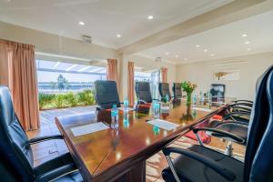 a conference room with a long wooden table and chairs at The Anchorage in Vaal Marina