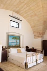 a bedroom with a bed and a window with the ocean at Masseria Filippo de Raho - Agri Bio Relais in Villa Convento +88 photos