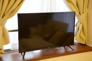 TV a/nebo společenská místnost v ubytování BAi歌舞伎町2丁目