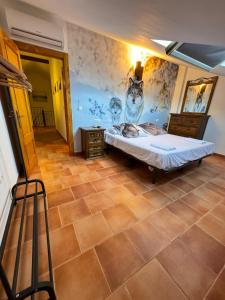 a bedroom with a bed and a wall with a mural at La lobera in Arroyo Frio