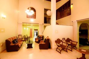 a living room with couches and chairs and a table at The House Dewata in Galle