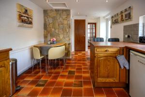 a kitchen with a counter and a table and chairs at Frodo's Folly in Port Talbot