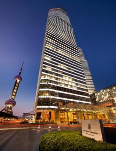 a tall skyscraper with a view of a tv tower at The Ritz-Carlton Shanghai, Pudong in Shanghai