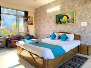 a bedroom with a large bed in a room at kasauli Auriga 2BHK Villa Pvt Stay I Open Air Terrace I Kitchen Livingroom I Lawn Bonfire I Gaming Zone in Kasauli +67 photos