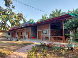 a house with a patio and a table at Yoga Homestay Seka in Seka