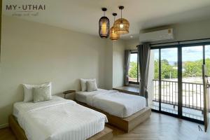 Ένα ή περισσότερα κρεβάτια σε δωμάτιο στο My Uthai Hotel