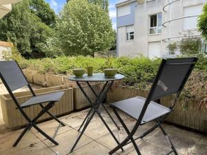 two chairs and a table on a patio at Appt Studio LA ROCHELLE - LR010-031 in La Rochelle