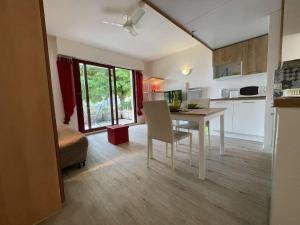 a kitchen and living room with a table and a dining room at Appt Studio LA ROCHELLE - LR010-031 in La Rochelle