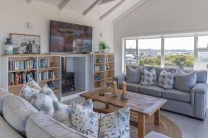 a living room with a couch and a table at Simply Stunning but smaller in Cape St Francis