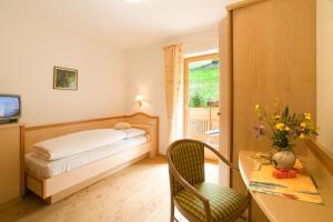 Postel nebo postele na pokoji v ubytování Hotel Garni Alpes