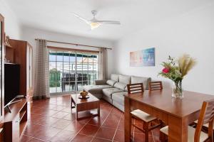 a living room with a couch and a table at Casa Oliveira in Conceição