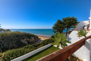 a view of the beach from the balcony of a house at Villas Flamenco Beach Conil in Conil de la Frontera