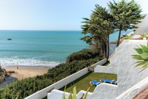 a view of the beach from the balcony of a house at Villas Flamenco Beach Conil in Conil de la Frontera