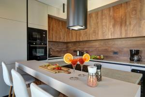 a kitchen with a table with two wine glasses on it at Pieron & Bavigo Villas - Spa Oasis in Marčana +25 photos