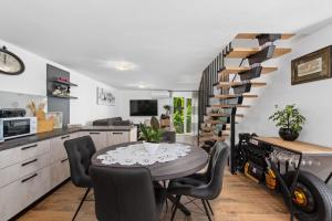 a kitchen and dining room with a table and chairs at Holiday Home Sea in Premantura +24 photos