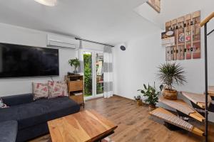 a living room with a couch and a tv at Holiday Home Sea in Premantura