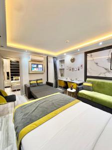 a bedroom with a large bed and a living room at TAKSİM LARİSSA RESİDENCE in Istanbul