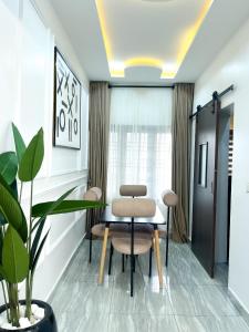 a meeting room with a table and two chairs at Fully Furnished Modern 2 bedroom in jahi in Abuja