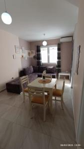 a living room with a table and chairs and a couch at ILSA Apartment in Durrës