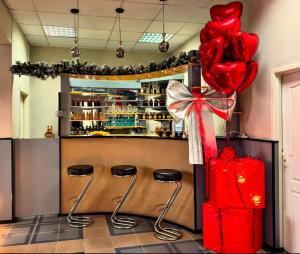 a room with three stools and a red balloon at Hotel Anastasia in Rezina